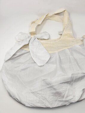 New white cloth handbag with ivory cloth handles.
